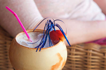 Cocktail with strawberry and pink straw, close up, with text space.の写真素材