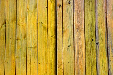 Yellow faded wooden doors / planks / panels / vertical slats - Stripes Pattern as a Background Texture.の写真素材