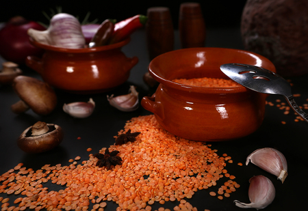 Raw vegetables and lentils on a black backgroundの写真素材