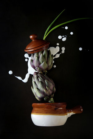 Raw vegetables for cooking-artichokes, green onions, cream. Concept for a poster, flyer, or menu.の写真素材