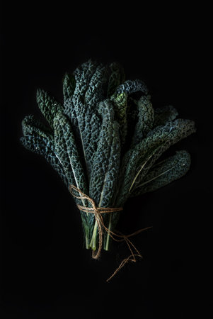 Green Tuskan Kale leaves on a dark background. Healthy detox vegetables. Clean eating and dieting concept. Top view. Health kale benefitsの写真素材