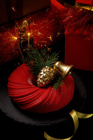 Mousse cake covered with red velour.Modern european cake. French cuisine. Christmas themeの写真素材