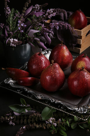 Red pears Red Bartlett sort in a low key on the black background. Dark photo with the pears.の写真素材