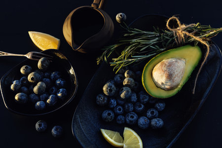 Avocado and blueberry. Healthy vegan food concept. Dark background, topの写真素材