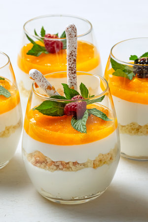 Orange cheesecake in glasses on white background.の写真素材