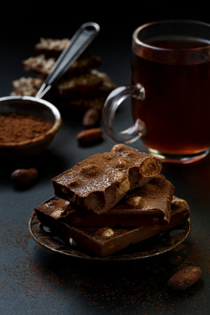 Chocolate chunks and cocoa powder. Slices of chocolate, Sweet food photo concept.の写真素材