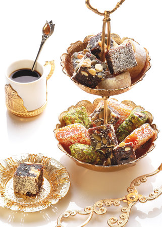 Turkish sweets with nuts and coconut on a white plate. Organic food.の写真素材