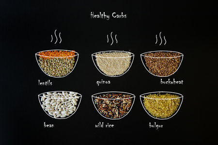 Diet food background concept, healthy carbohydrates carbs products. Different cereals and garnish - best sources of Carbs. Black background, flat lay.の写真素材