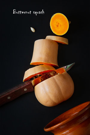 Sliced organic fresh butternut squash on a black background. Healthy organic food collection. Top view flat layの写真素材