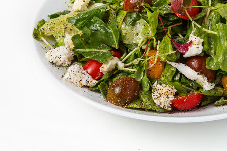 salad with arugula and feta cheese on a white backgroundの写真素材