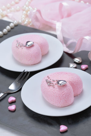 Little pink mousse cakes in the shape of a heart. St. Valentine's Dayの写真素材