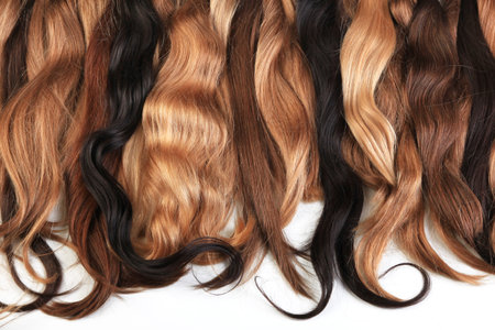 Mix of natural extensions hair: blond, red, brown. Strands of hair for hairstyles. Isolated on white background.の写真素材