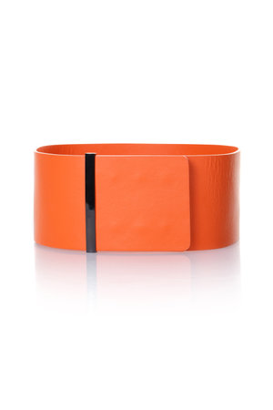 Women's wide leather belt of orange color on a white backgroundの写真素材