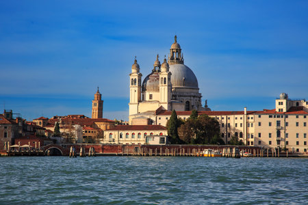 Iconic view of Santa Maria della Salute basilica in Venice, Italy, seen from across the Grand Canal on a sunny day with clear blue skies.の写真素材