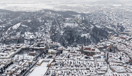 Brasov, Transylvania. Romania. Panoramic view of the old town and Council Square in the winter time, Aerial cityscape of Brasov city, Transylvania landmark in Romania. High quality photoの写真素材