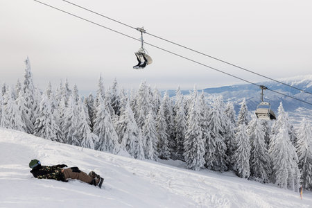 Chairlift over snowy forest in Poiana Brasov, Romaniaの写真素材