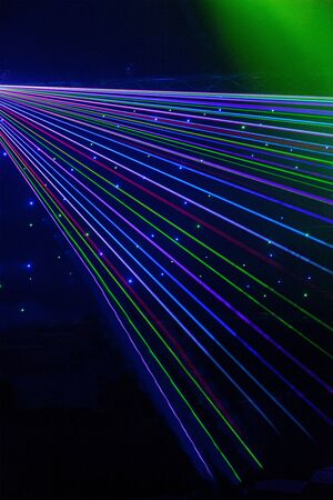 Bright nightclub red, green, purple, white, pink, blue laser lights cutting through smoke machine...