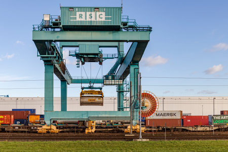Rotterdam, Netherlands - 01-13-2021: Crane loading containers on a train at RSC rail terminal in...