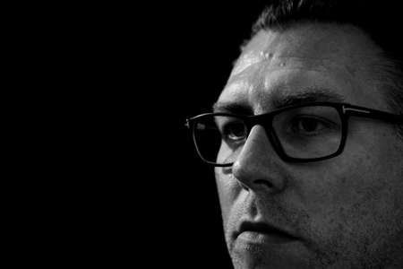 Portrait of a depressed caucasian male wearing glassesの写真素材