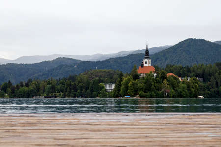 church of the mother of god on the lake in Bled, Slovenija on a cloudy dayの写真素材