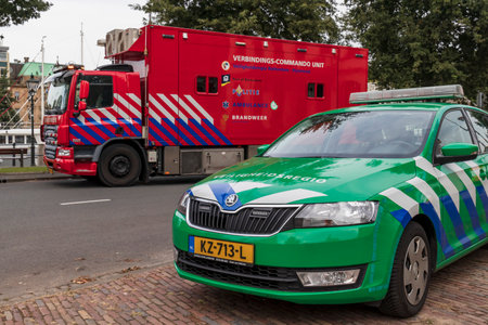 Rotterdam, Netherlands - 2019-9-6: A Dutch firefighting command and support unit and a safety region vehicle outside on the streetsのeditorial素材