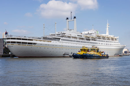 Rotterdam, the Netherlands - 2021-07-09: SS Rottrdam accompanied by two vessels of the Rotterdam port authority on a sunny dayのeditorial素材