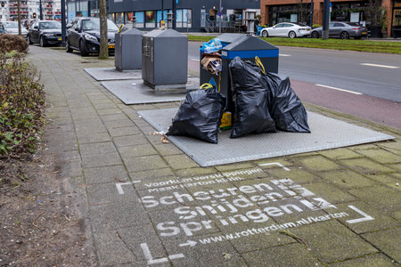Rotterdam, Netherlands - 2021-01-18: Underground container for collection of paper waste to recycle. The container is full and garbage has been dumped besides it.のeditorial素材