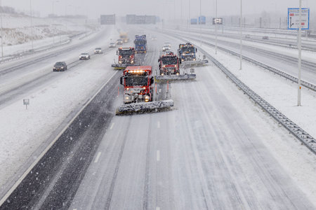 Rotterdam, Netherlands - 2021-02-07: Snowplows clearing the Rotterdam highway during winter snow conditionsのeditorial素材