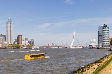 Rotterdam, the Netherlands - 2022-04-21: Amphibious bus floating in the river in Rotterdam as a tourist attraction with the city skyline in the backのeditorial素材