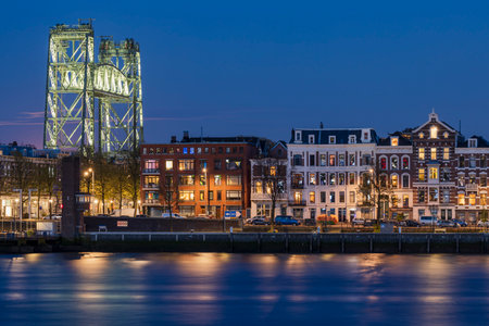 The north island Maaskade quay in Rotterdam with the historic railway bridge in the eveningのeditorial素材