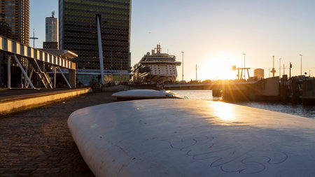 Rotterdam, the Netherlands - 2022-010-18: Beautiful sunset at Rotterdam Wilhelminakade quay with a cruiseship at the cruise terminalのeditorial素材