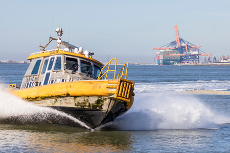 Rotterdam, the Netherlands - 2022-02-26: A small vessel of KRVE boatsmen service in the port of Rotterdam at high speedのeditorial素材