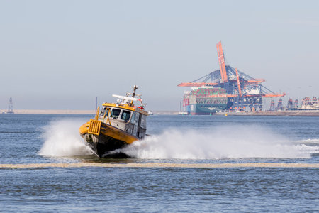 Rotterdam, the Netherlands - 2022-02-26: A small vessel of KRVE boatsmen service in the port of Rotterdam at high speedのeditorial素材