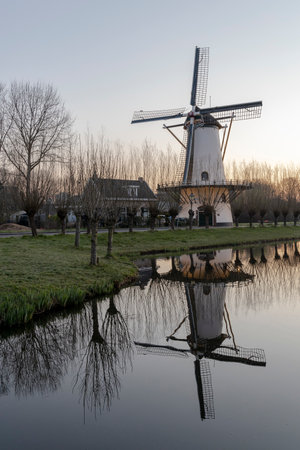 Scenic view of the historic windmill of Zandweg, Rotterdam with a reflection in the waterのeditorial素材