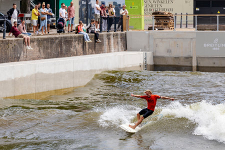 Rotterdam, Netherlands - 30-06-2024: A surfer at Rif010 urban surf pool in the city center of Rotterdam, the Netherlandsのeditorial素材