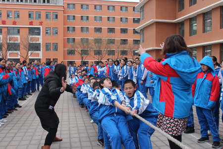 Students pulling rope during tug of war game