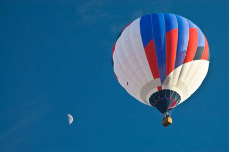 Hot Air Balloon in the blue sky with moonの写真素材
