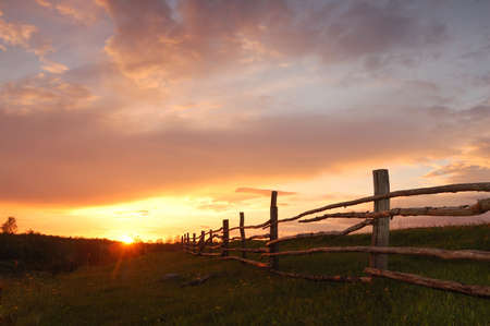 Spring sunset with a wooden fenceの写真素材