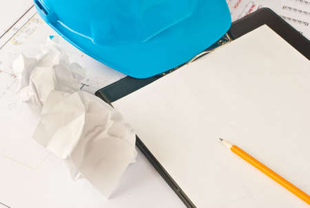 Yellow pencil on  white paper with protective helmetの写真素材