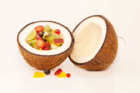 Tropical fruits and berries placed in the coconutの写真素材