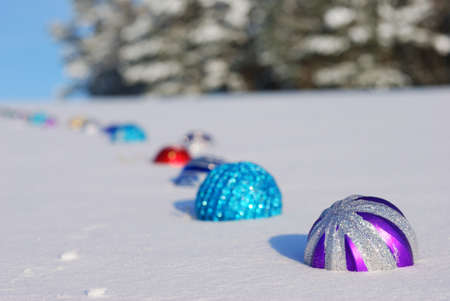Christmas and New Year decoration - color balls on snow backgroundの写真素材