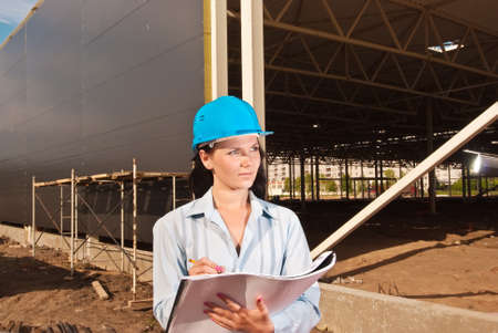 Young engineer at  construction site with building projectの写真素材