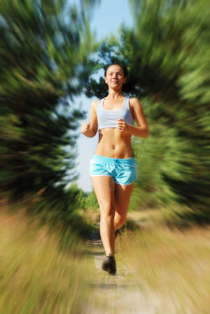 Young attractive girl running on the morning (motion blur)の写真素材