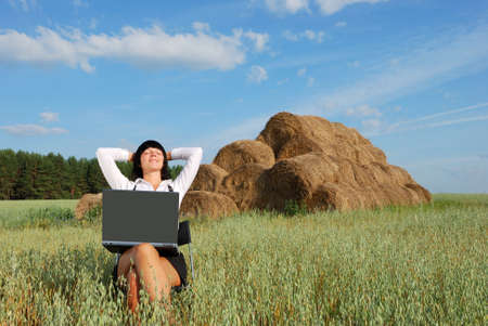 Young attractive girl with  laptop on  agricultural fieldの写真素材