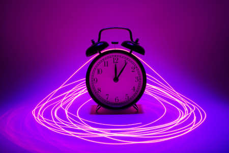 Pink and blue concept clock in laser rings.の写真素材
