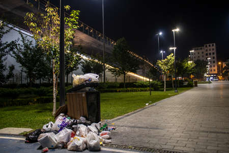 A beautiful park and HaliÃ§ Metro Bridge behind a nasty garbage bin. Environmental impact of human life.の写真素材