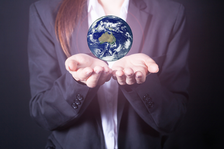 business woman earth on hands (Elements of this image furnished by NASA)の写真素材