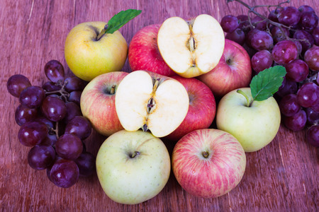 mixed set of fresh raw ripe fruits apple grape on isolated white backgroundの写真素材