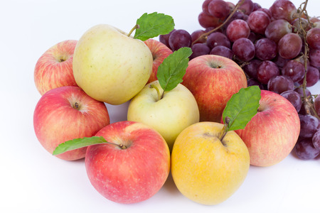 mixed set of fresh raw ripe fruits apple grape on isolated white backgroundの写真素材