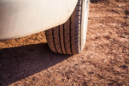 white for by four car on a sandy trailの写真素材